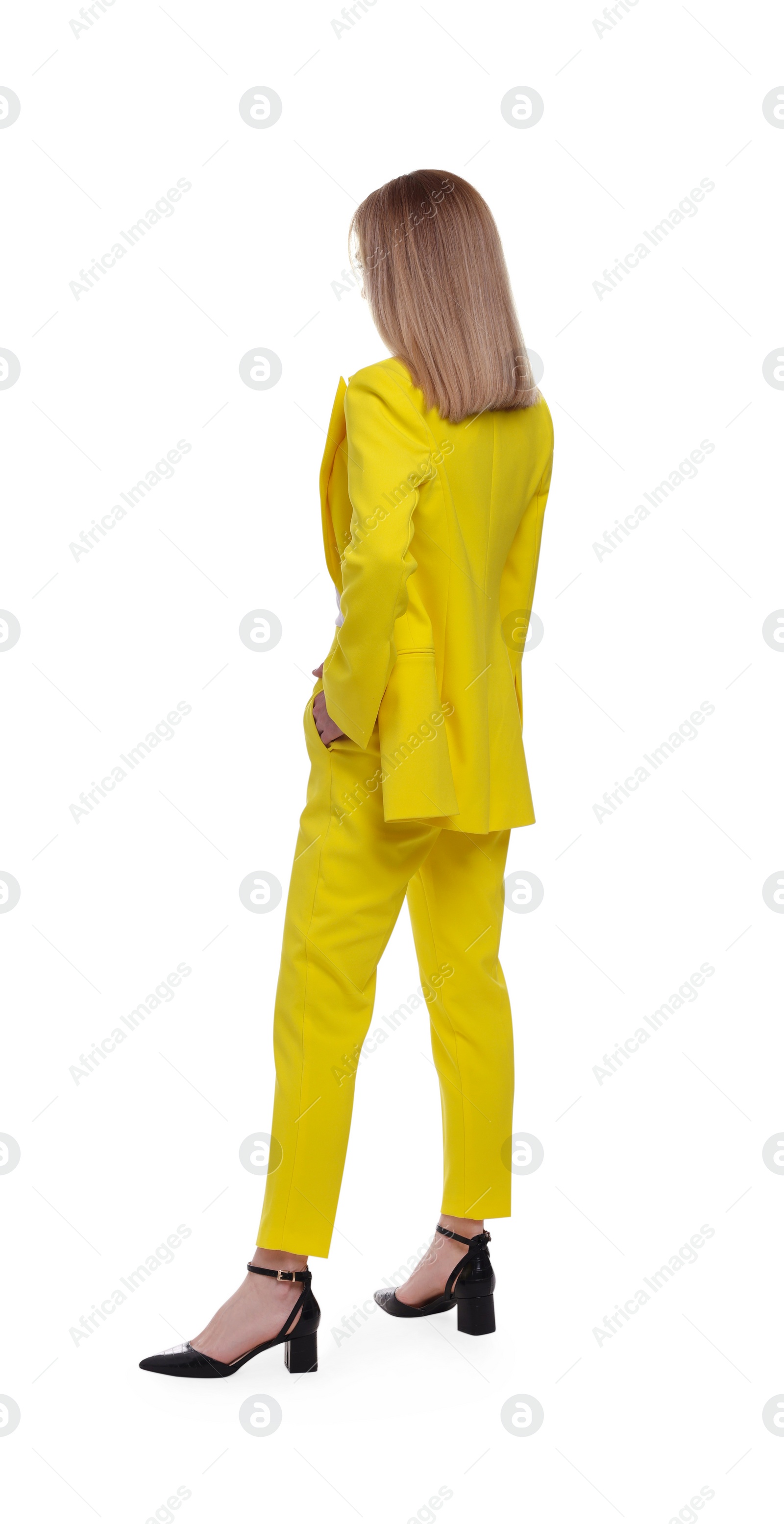 Photo of Businesswoman in suit standing on white background, back view
