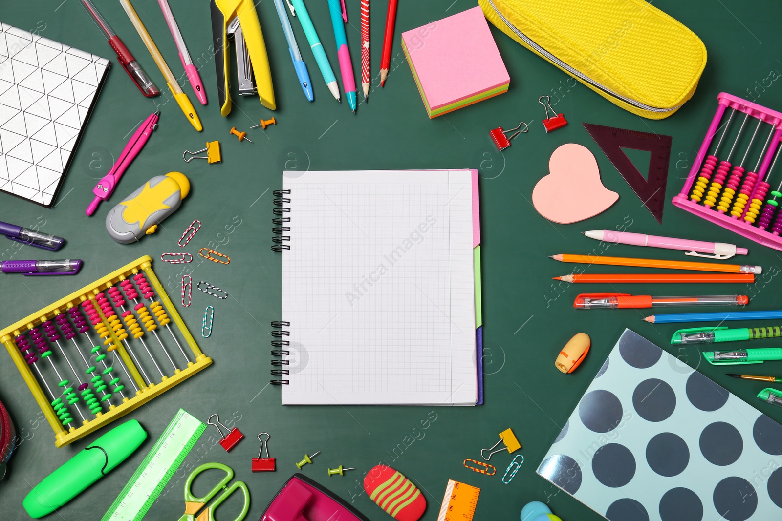 Photo of Flat lay composition with different school stationery on chalkboard surface