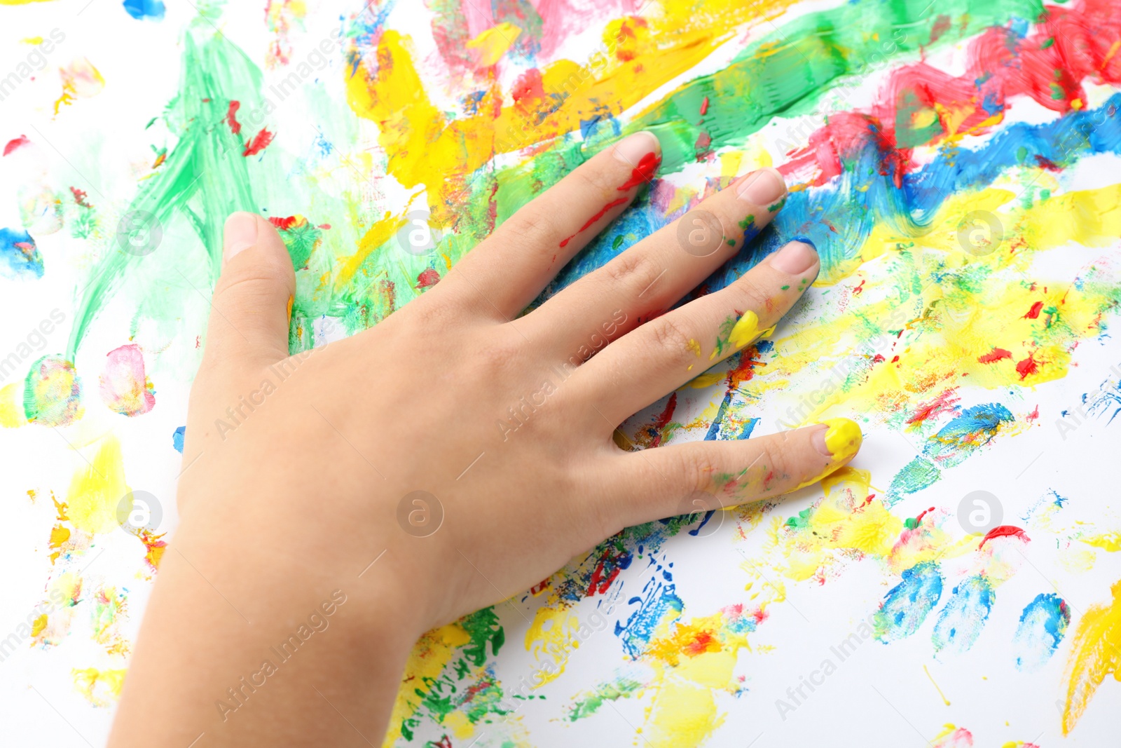 Photo of Child painting with hand on white background, closeup