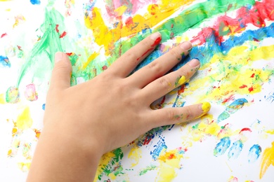 Photo of Child painting with hand on white background, closeup