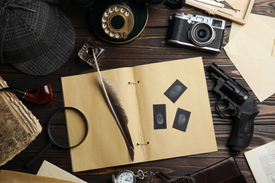 Flat lay composition with vintage detective items on dark wooden background