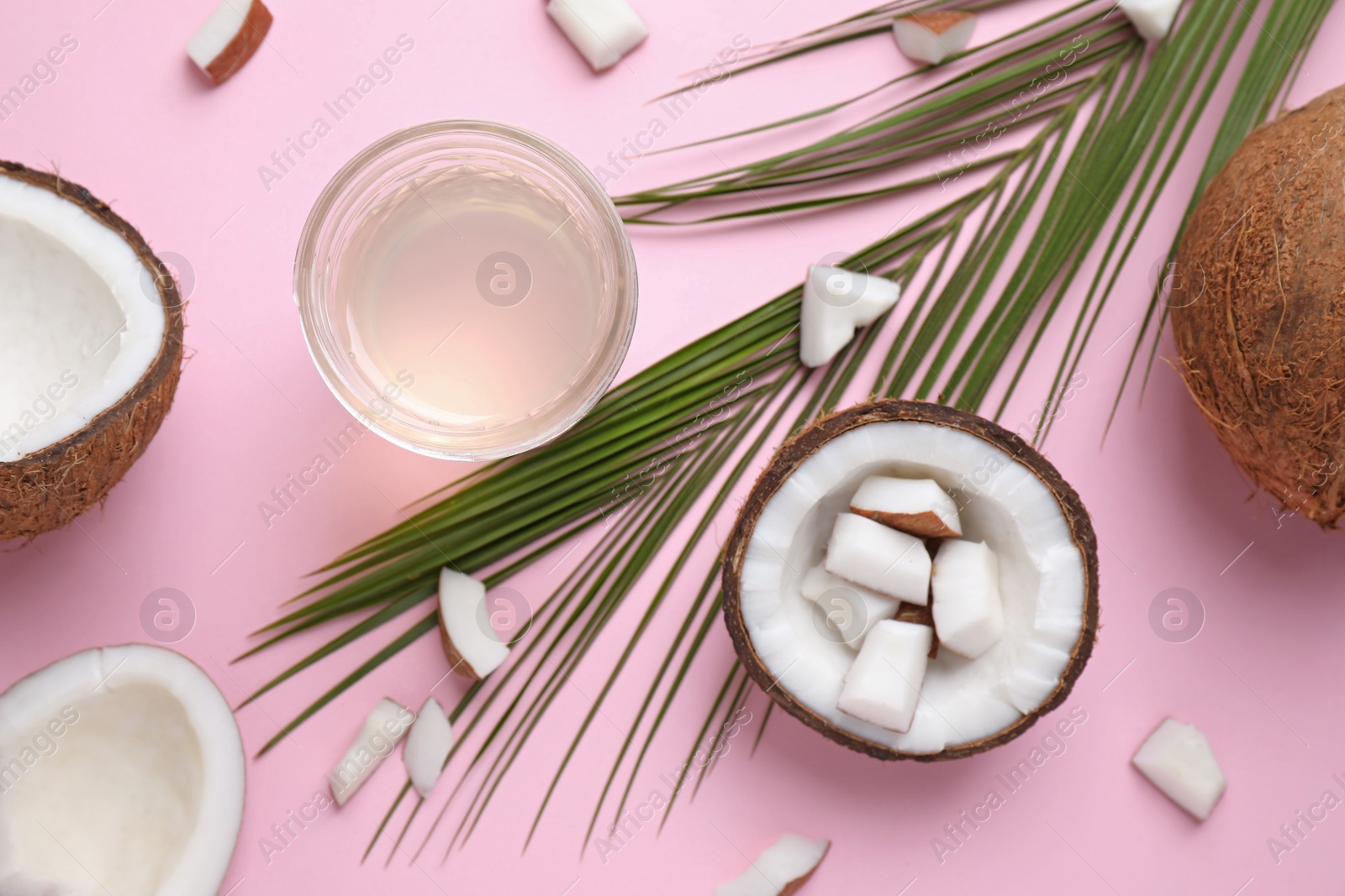 Photo of Flat lay composition with coconut oil on pink background