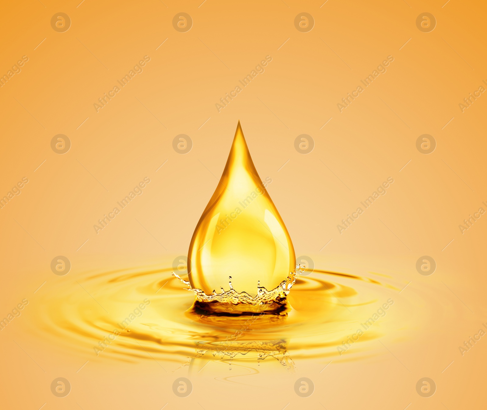 Image of Drop of cooking oil falling into oil on orange background