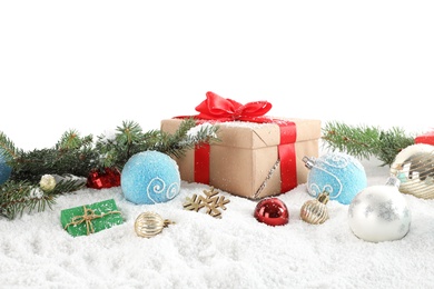 Fir branches, Christmas decoration and snow against white background