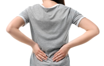 Young woman suffering from back pain on white background