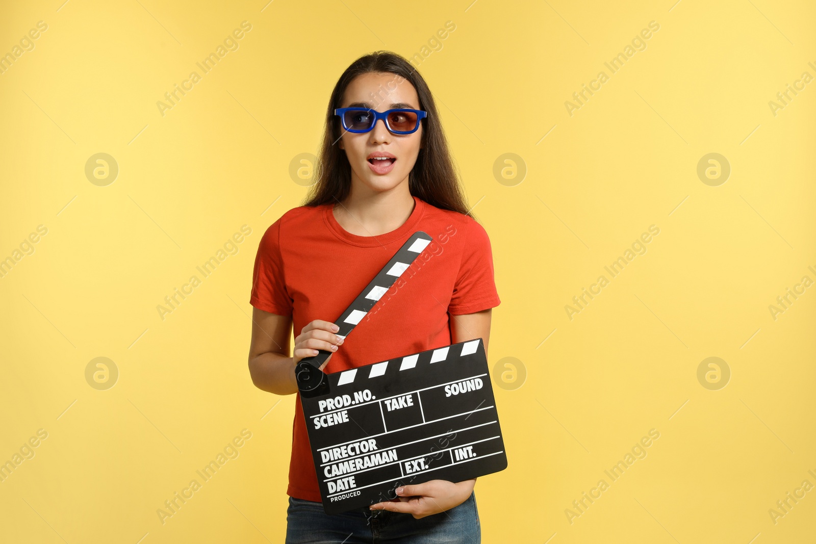 Photo of Woman with 3D glasses and clapperboard on color background. Cinema show