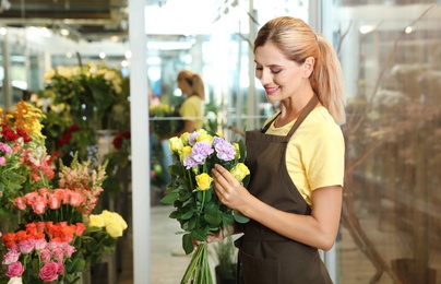 Female florist making beautiful bouquet in flower shop