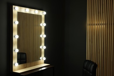 Photo of Beautiful mirror with light bulbs in makeup room