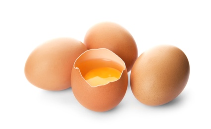 Photo of Raw brown chicken eggs on white background