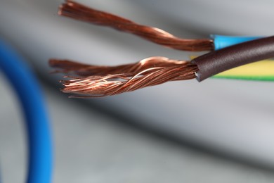 Photo of Colorful electrical wires on blurred background, closeup