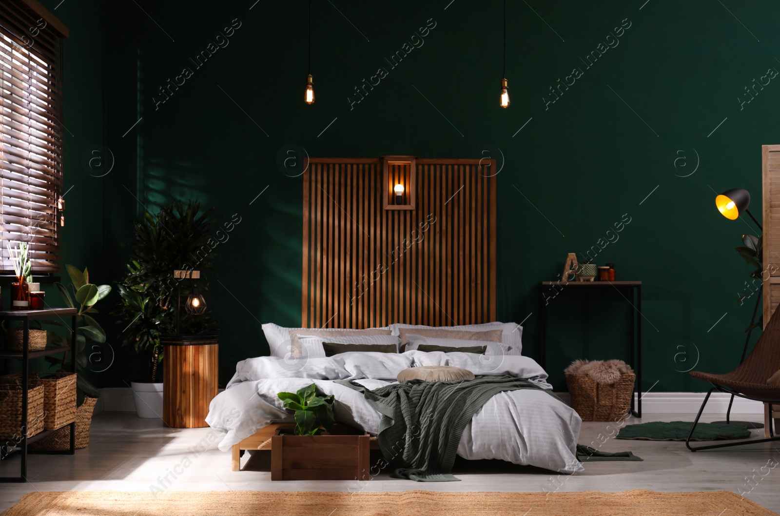 Photo of Stylish interior with large comfortable bed and potted plants