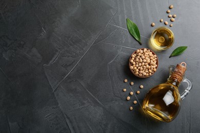 Flat lay composition with soybean oil on grey table, space for text