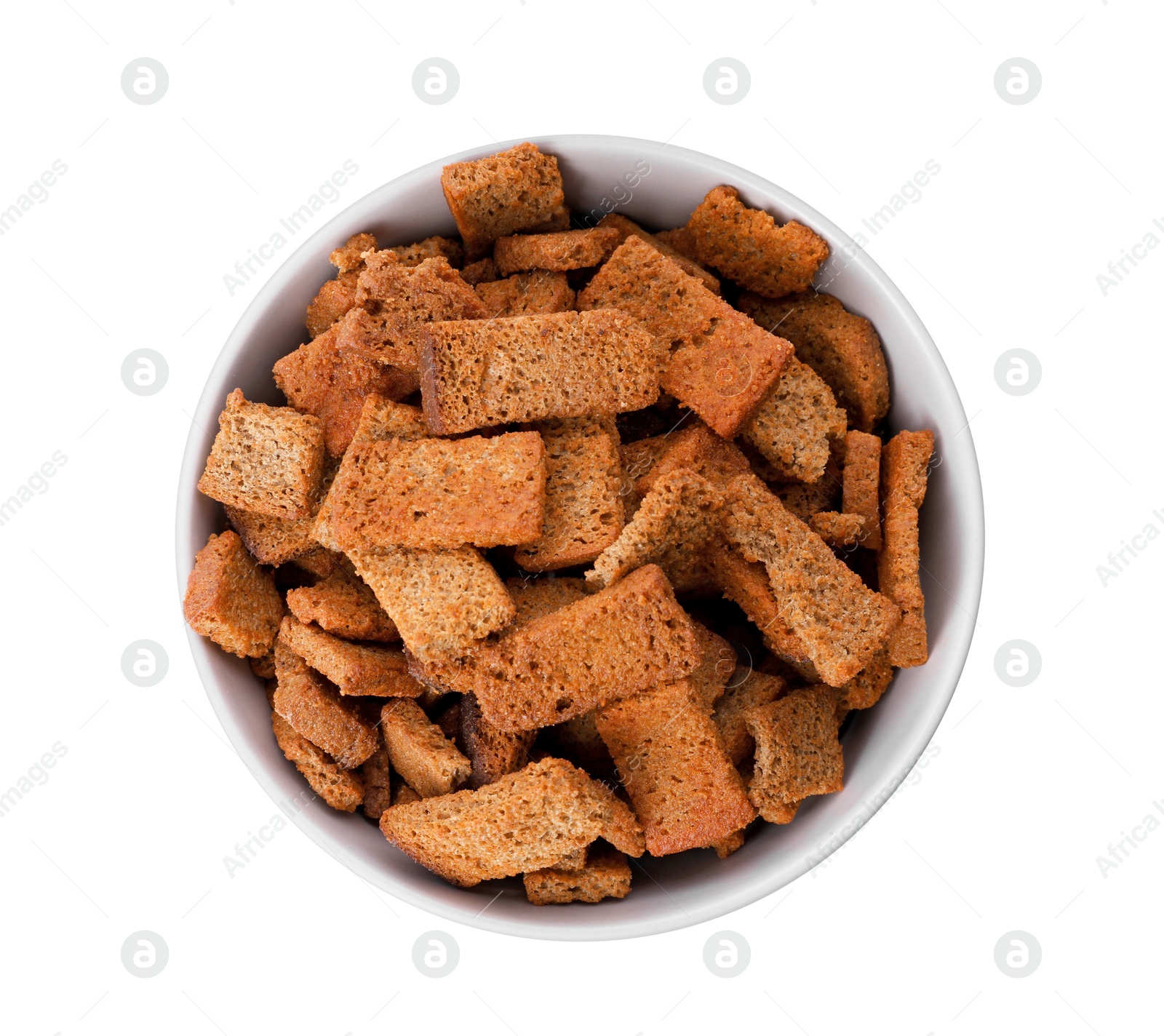 Photo of Crispy rusks with seasoning in bowl isolated on white, top view