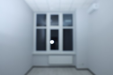 Photo of Blurred view of new empty room with windows