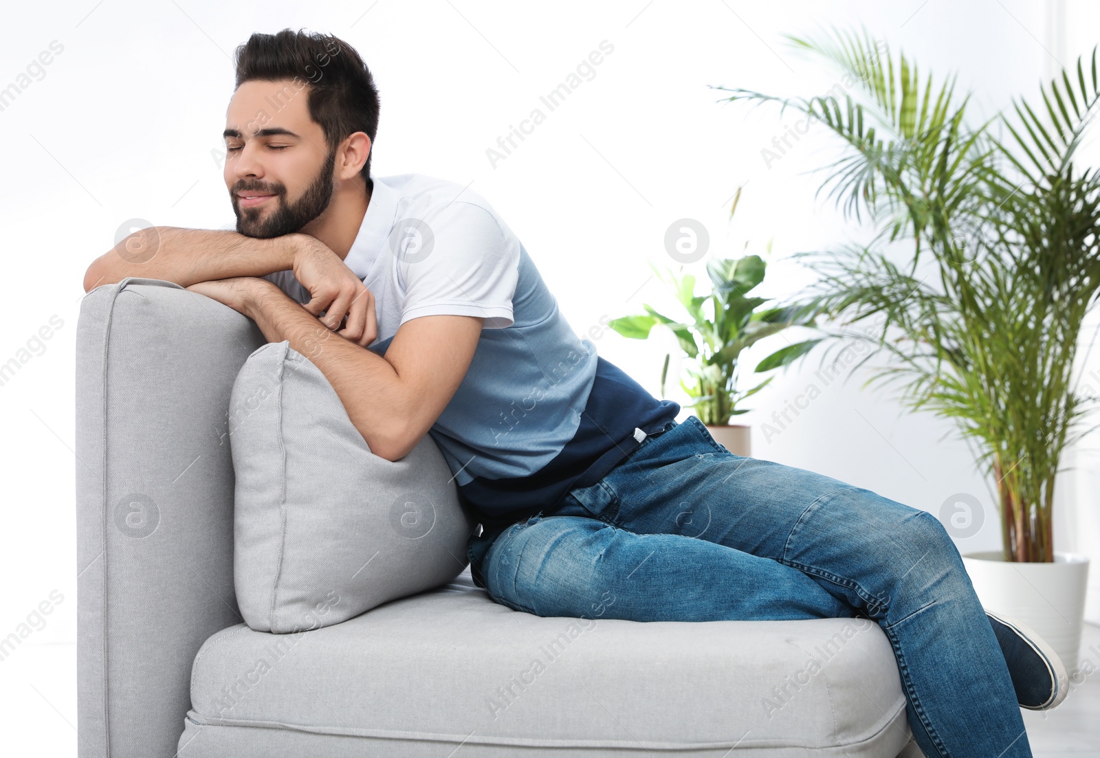 Photo of Young man relaxing on couch at home