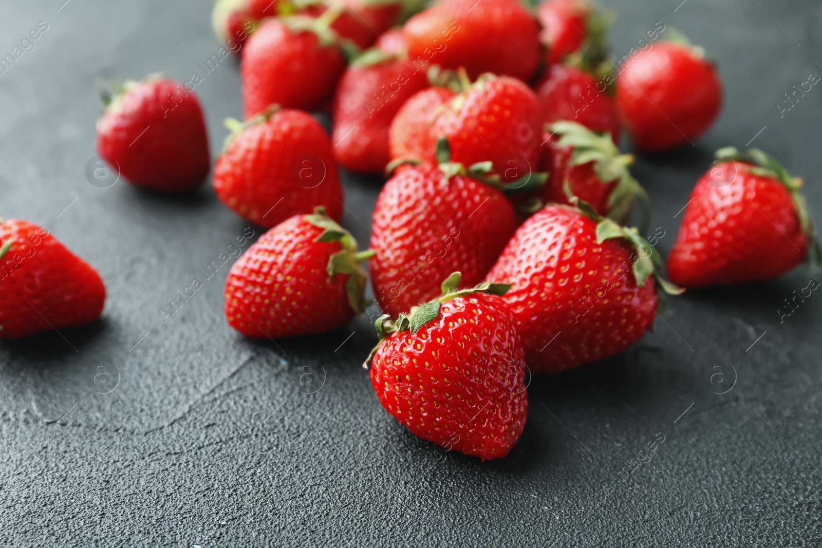 Photo of Ripe red strawberries on black background, closeup