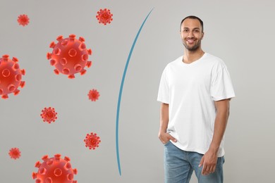 Man with strong immunity surrounded by viruses on grey background