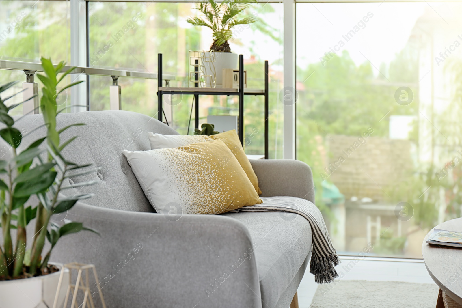 Photo of Elegant sofa with soft pillows in living room interior