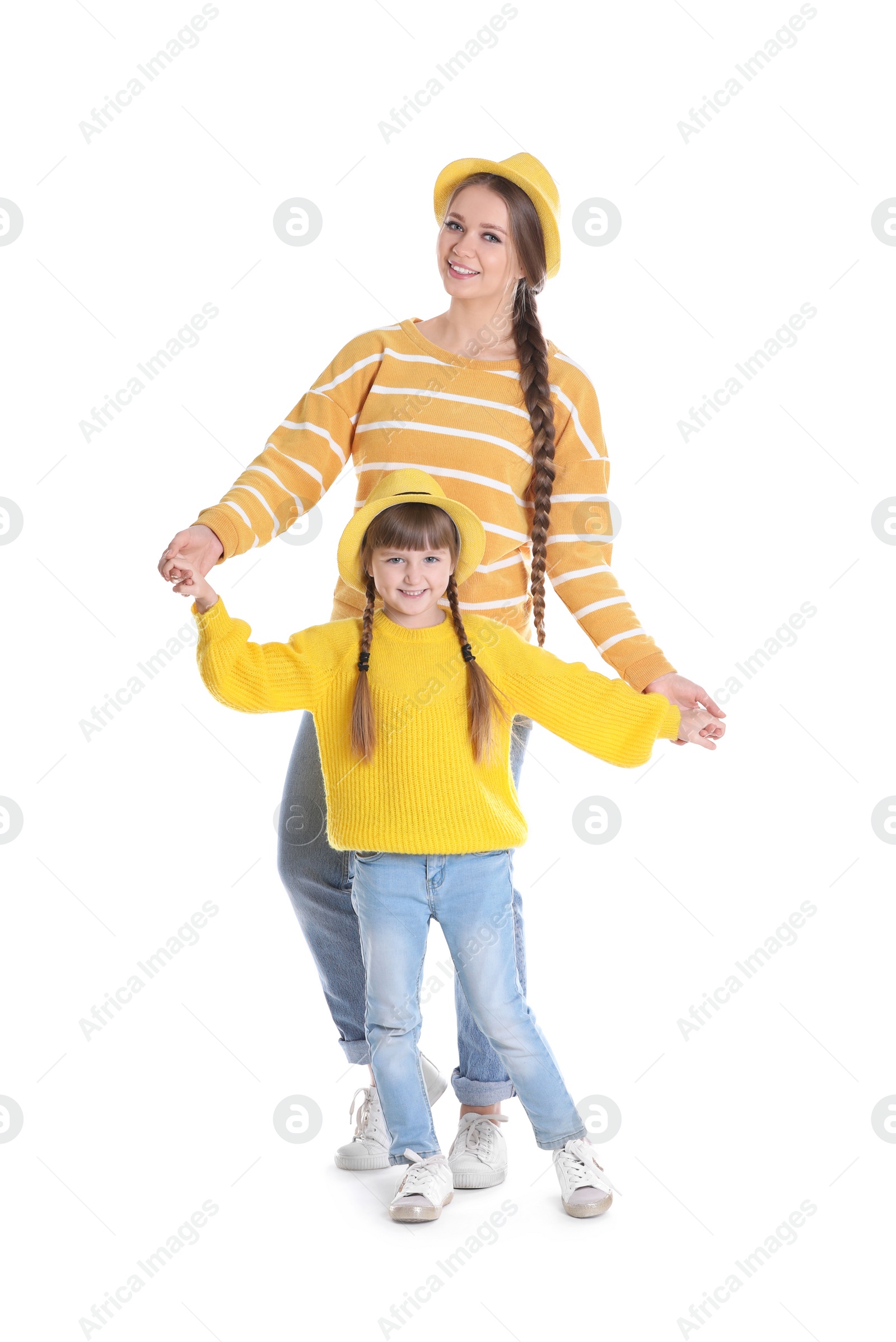 Photo of Happy woman and daughter in stylish clothes on white background