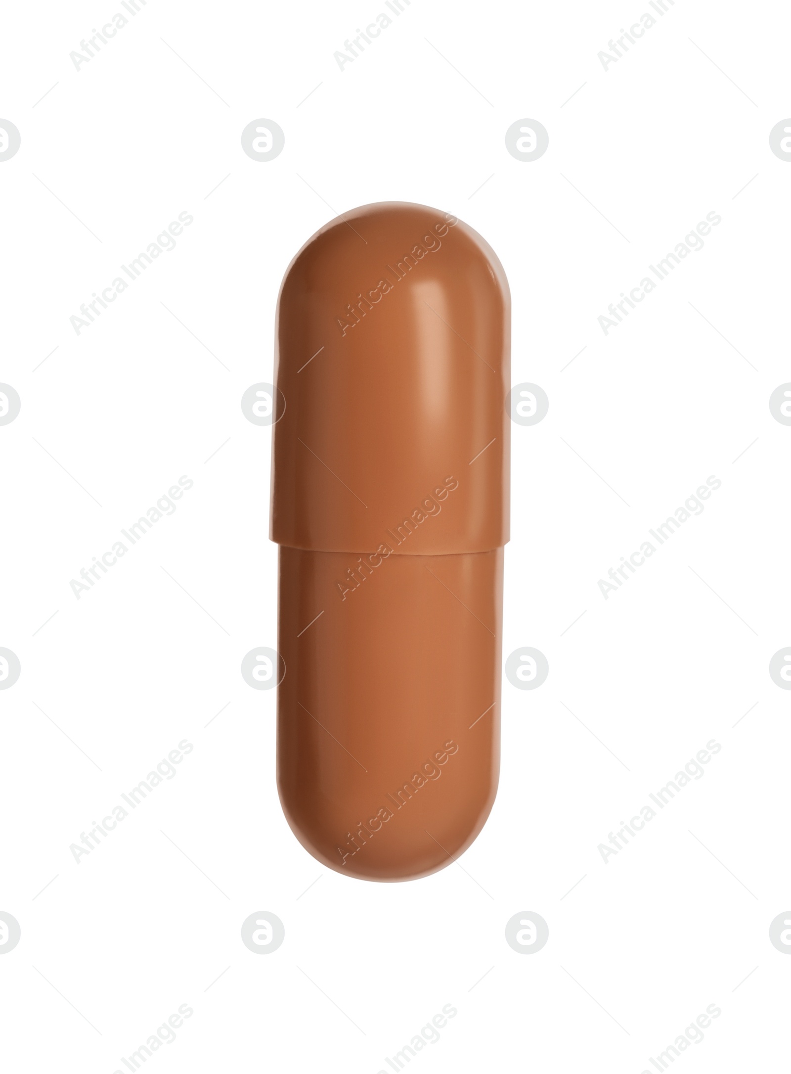 Photo of One brown pill on white background. Medicinal treatment