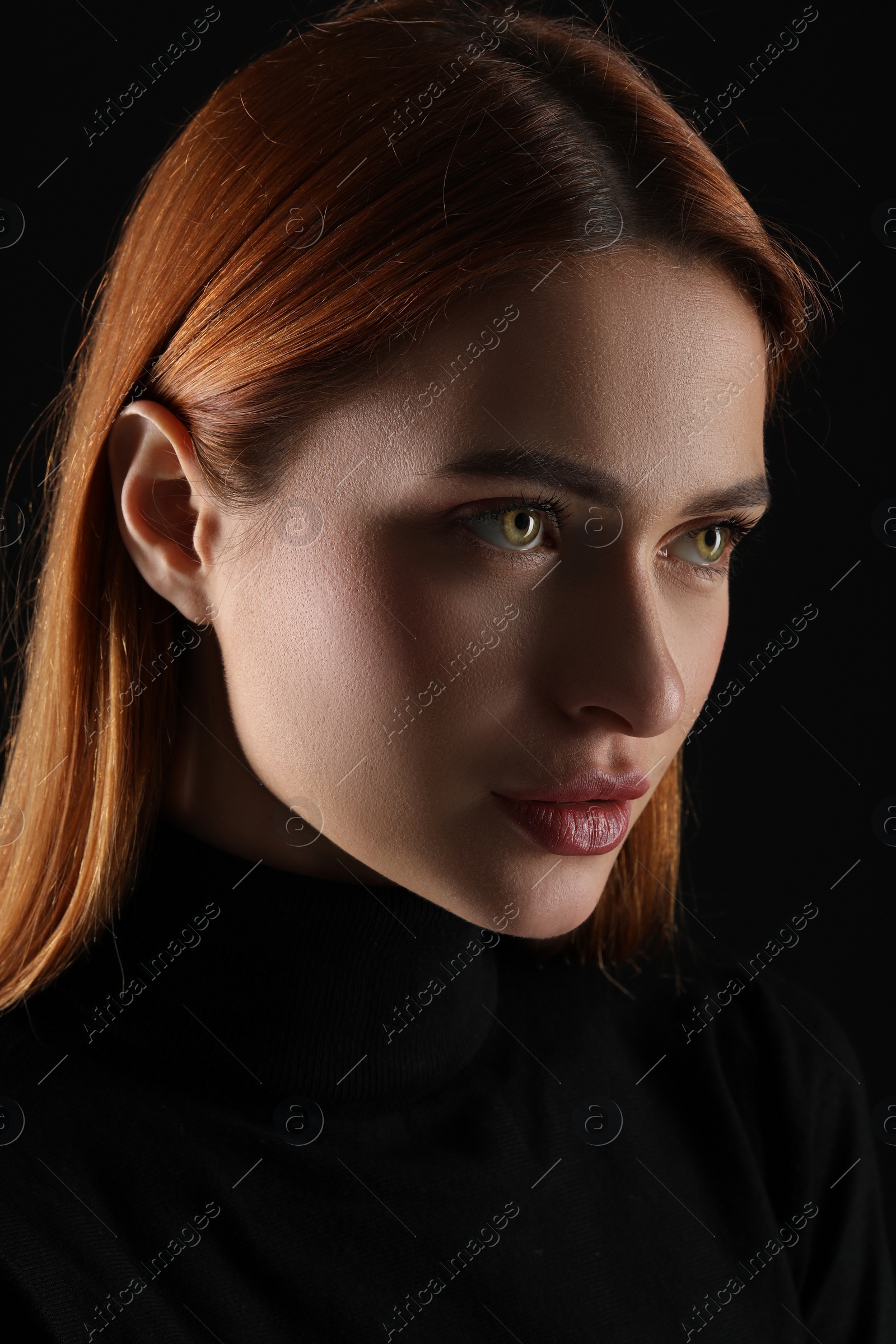 Photo of Evil eye. Young woman with scary eyes on black background