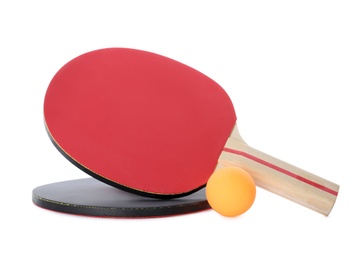 Photo of Orange plastic ball and rackets for table tennis on white background