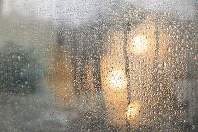 Closeup view of foggy window with rain drops