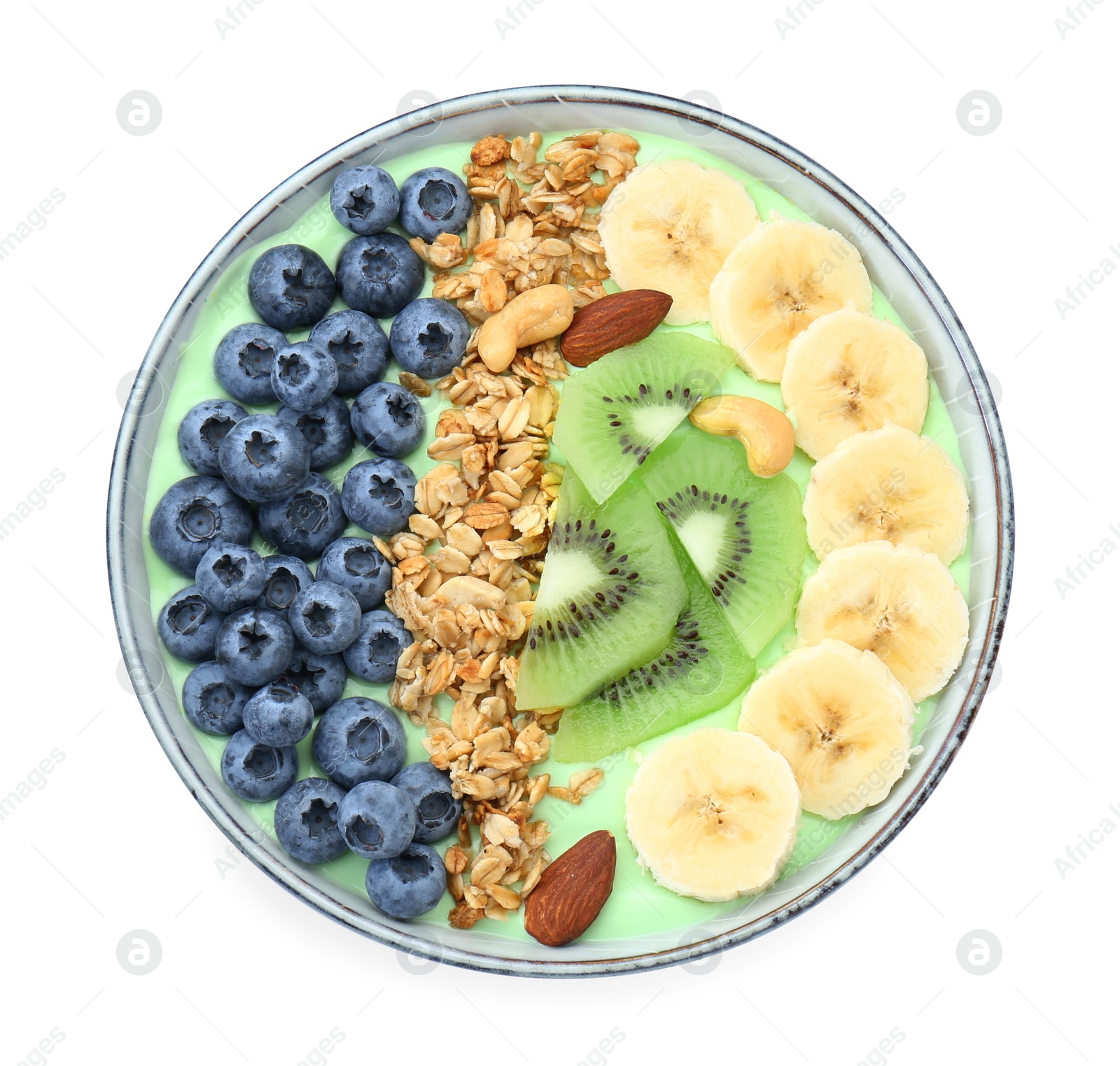 Photo of Tasty smoothie bowl with fresh fruits and oatmeal isolated on white, top view