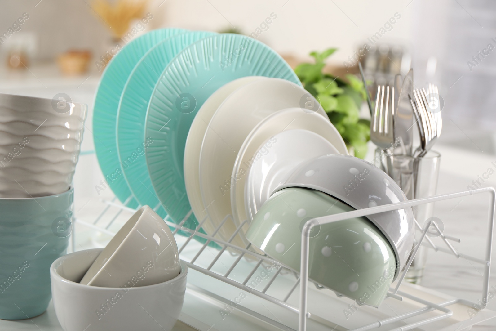 Photo of Many different clean dishware on white table indoors