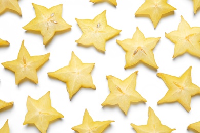 Slices of delicious carambola on white background, top view