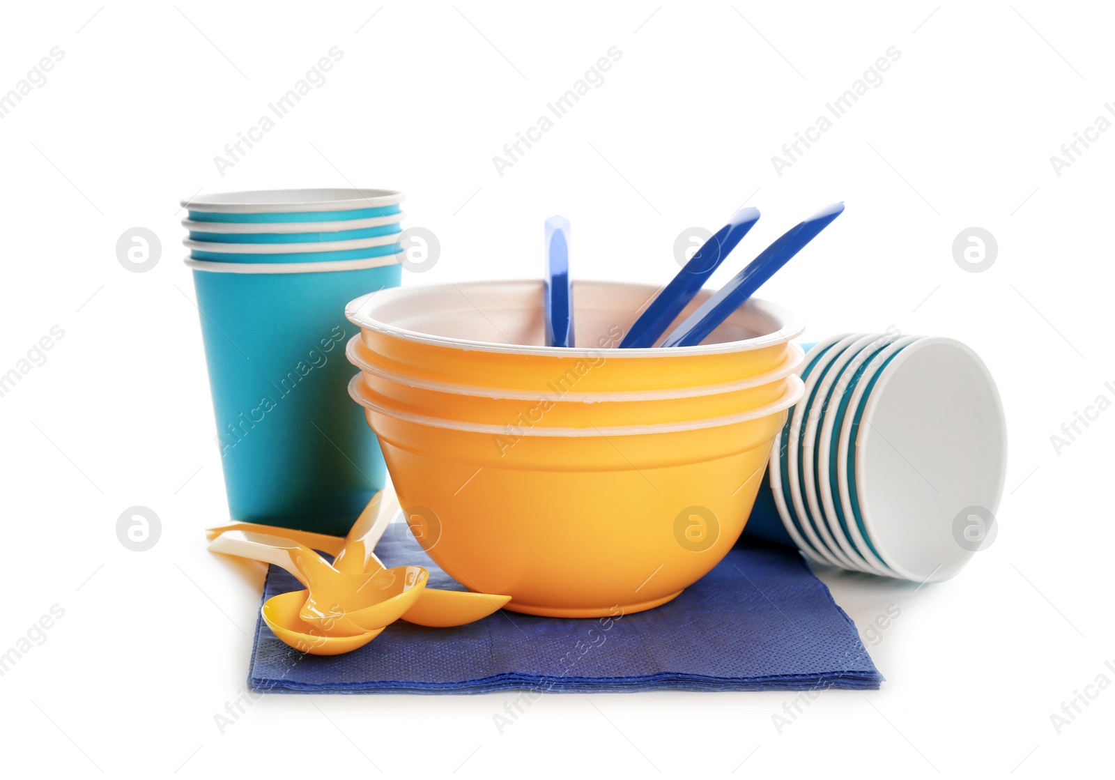 Photo of New plastic dishware and napkins on white background. Table setting