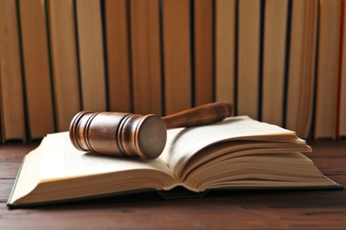 Photo of Wooden gavel and books on table. Law concept