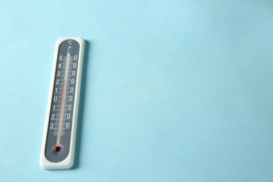 Photo of Weather thermometer on light blue background. Space for text
