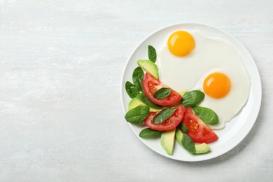Photo of Delicious breakfast with fried eggs served on table, top view. Space for text