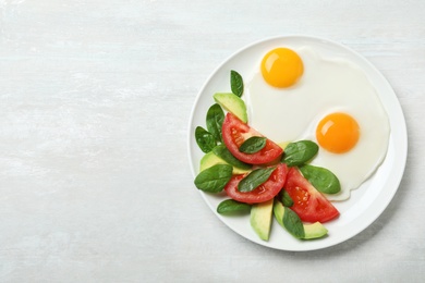 Delicious breakfast with fried eggs served on table, top view. Space for text