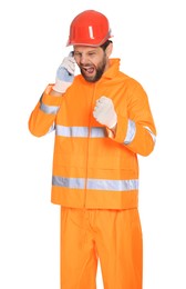 Photo of Man in reflective uniform talking on smartphone against white background