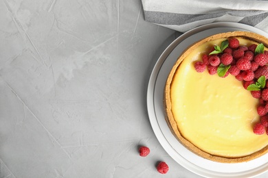 Photo of Dessert plate with delicious raspberry cake on grey table, flat lay. Space for text