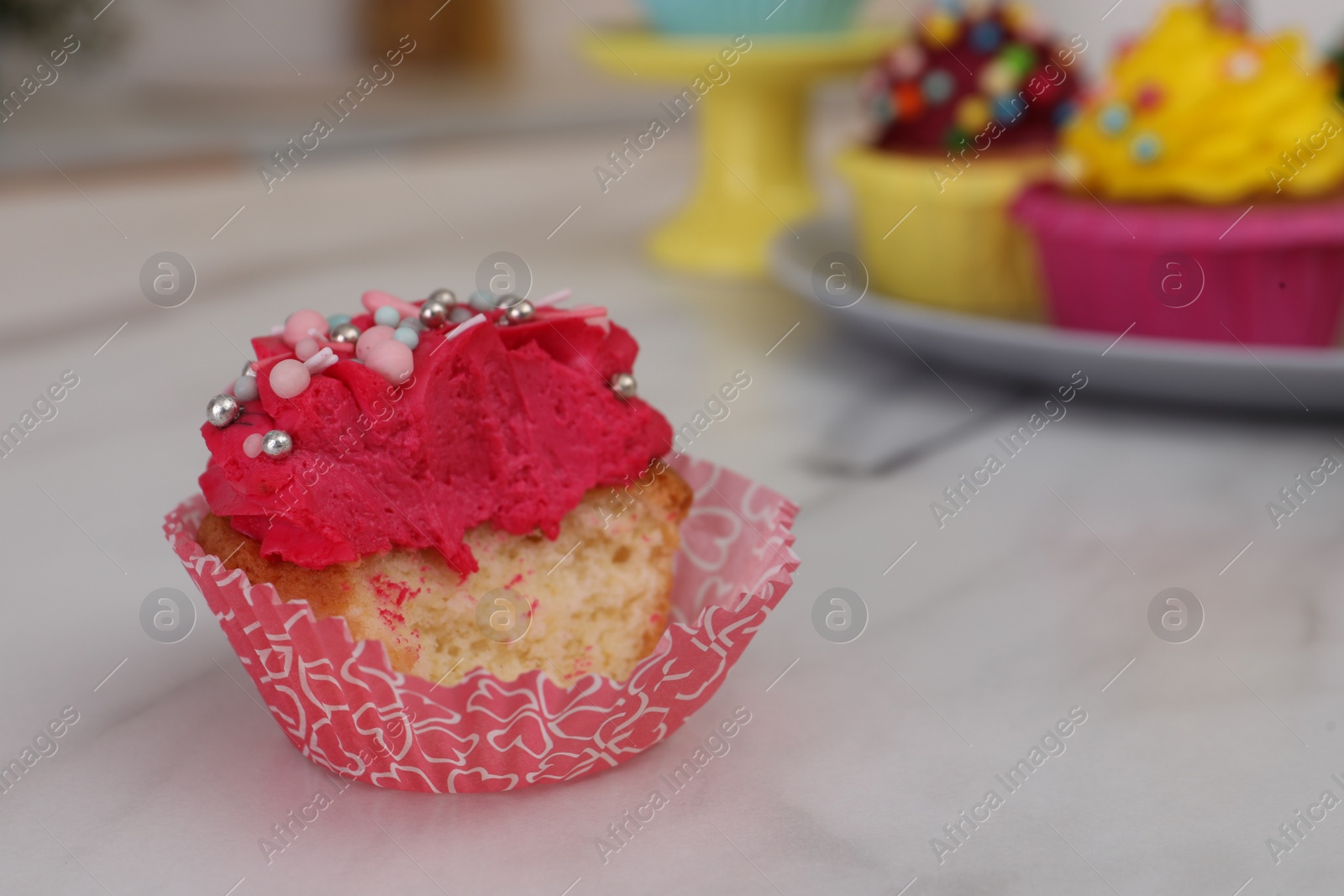 Photo of Failed cupcake with cream on light table. Troubles happen