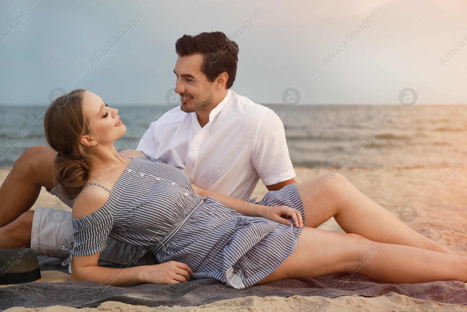 Photo of Happy young couple spending time at sea beach