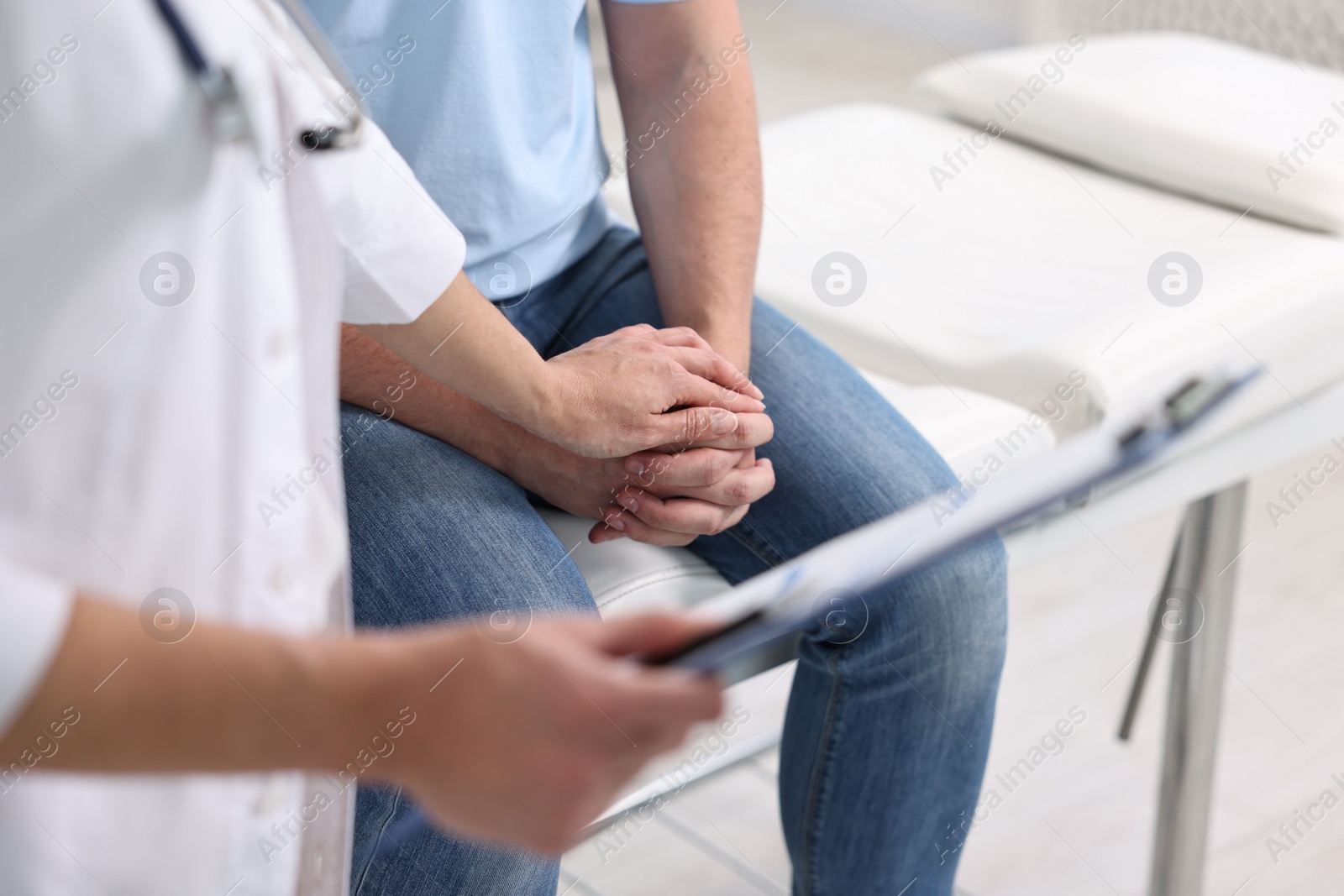 Photo of Professional doctor working with patient in hospital, closeup