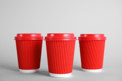 Photo of Carton cups on grey background. Mock up for design