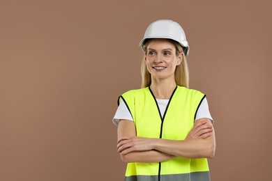 Photo of Engineer in hard hat on brown background