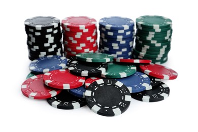 Photo of Plastic casino chips stacked on white background. Poker game