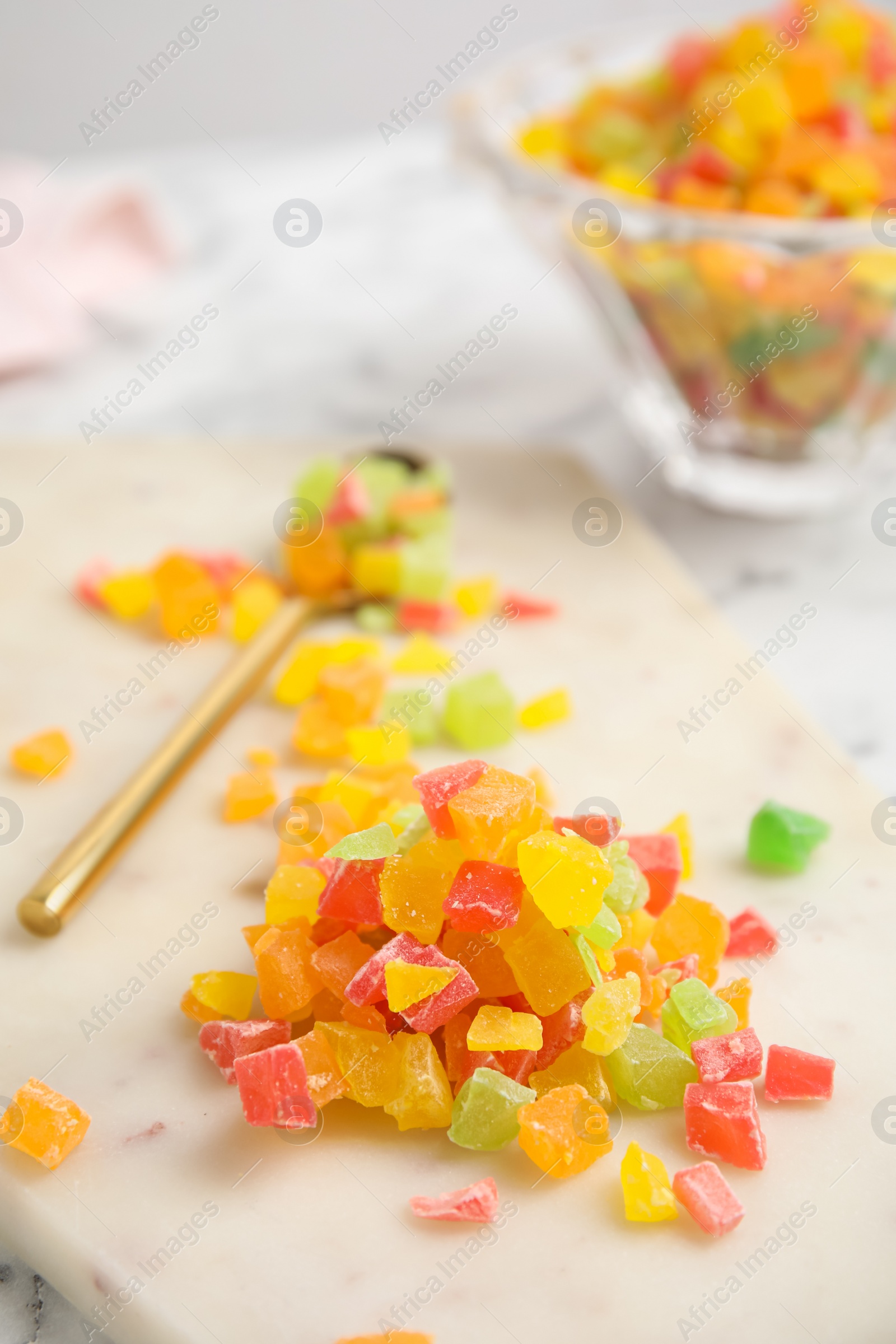 Photo of Mix of delicious candied fruits on white board, closeup