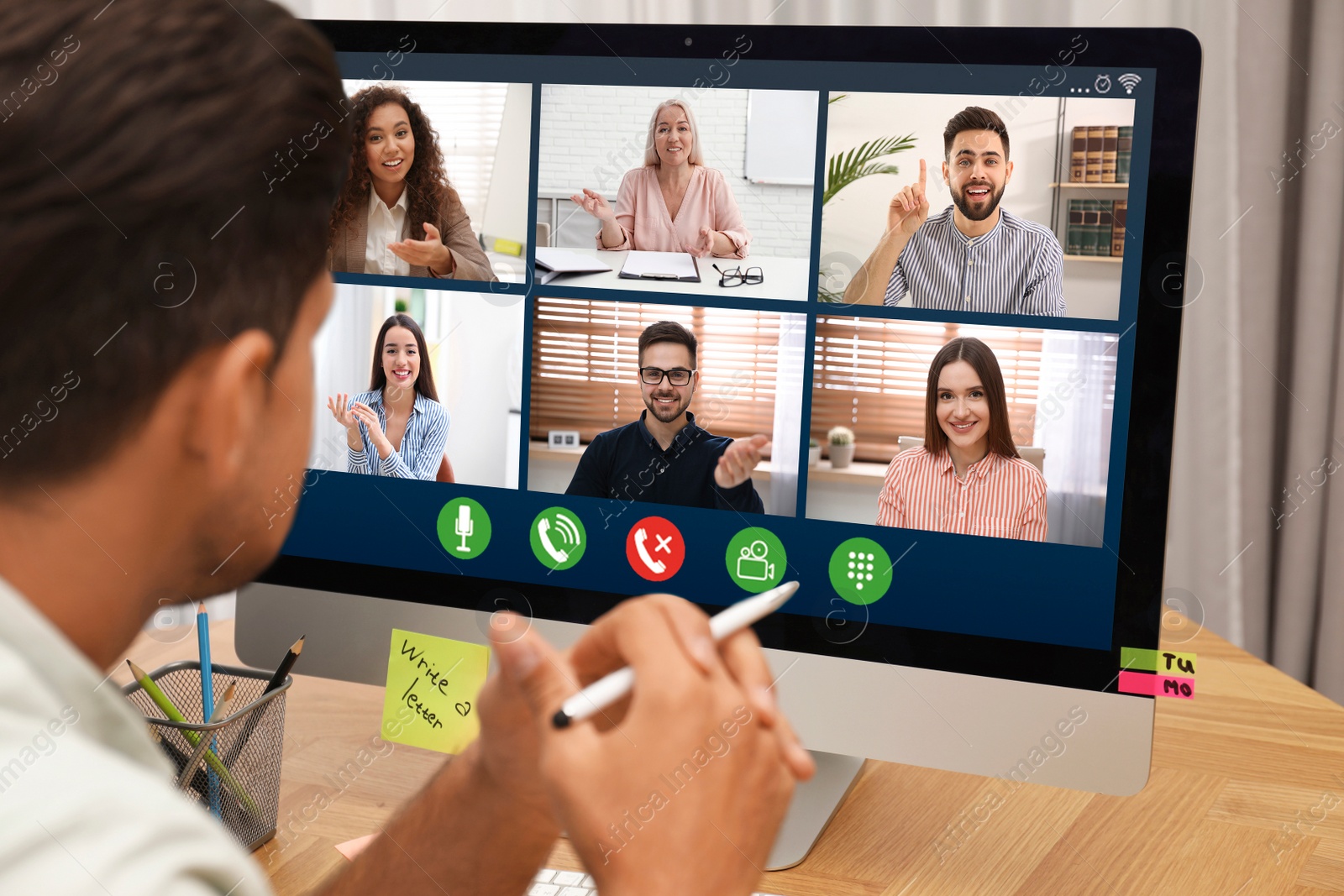 Image of Man having video chat with colleagues at table in office, closeup. Team work 