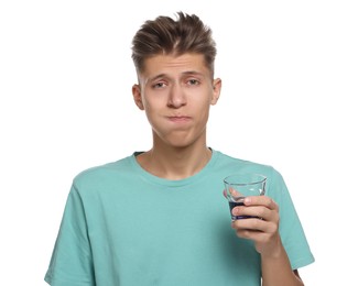 Photo of Young man using mouthwash on white background