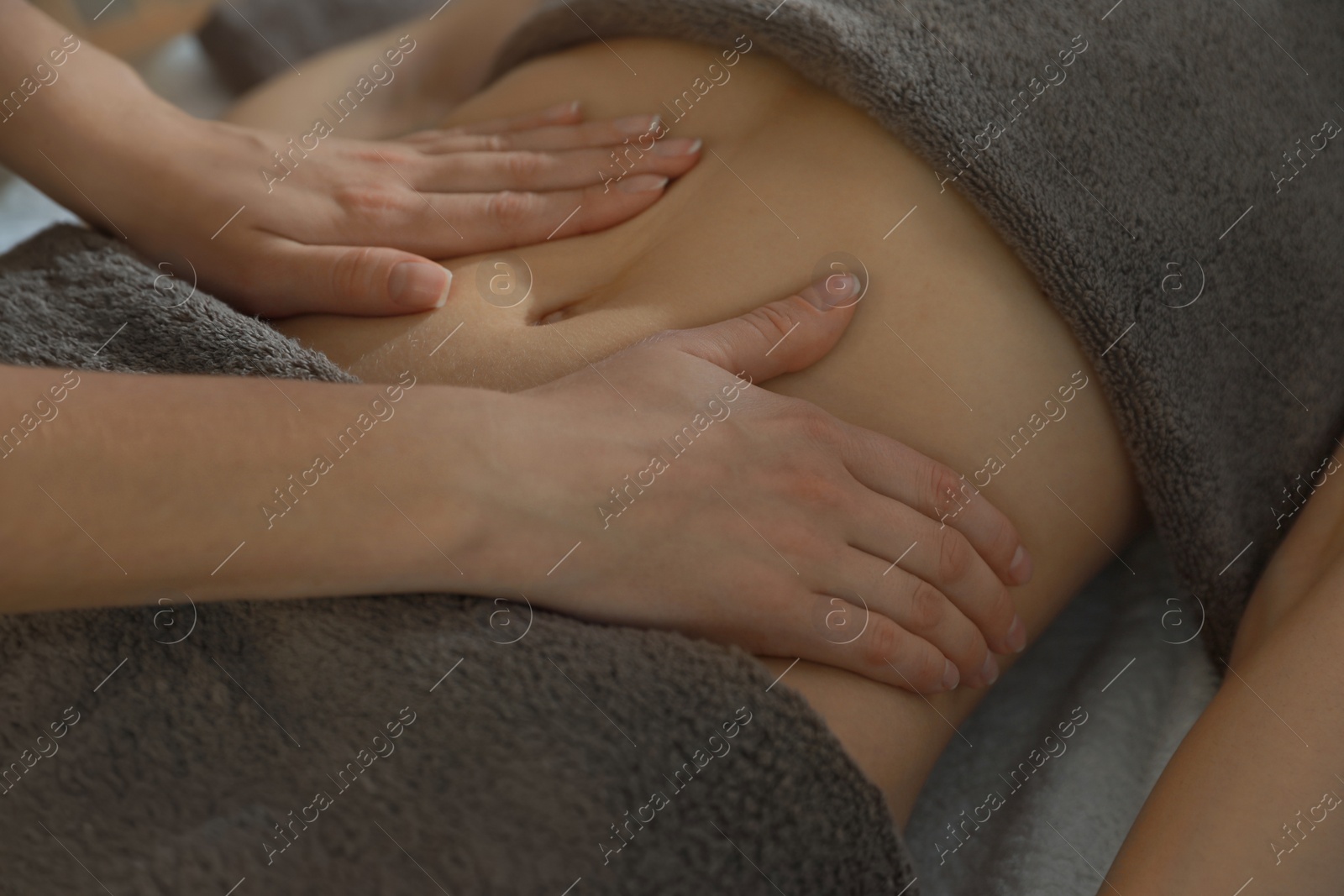 Photo of Woman receiving professional belly massage, closeup view