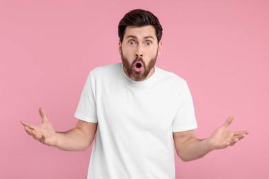 Photo of Portrait of surprised man on pink background