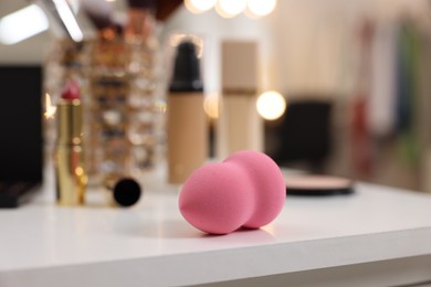 Makeup Sponge and other beauty products on white table indoors, selective focus
