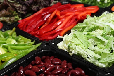 Photo of Salad bar with different fresh ingredients as background, closeup